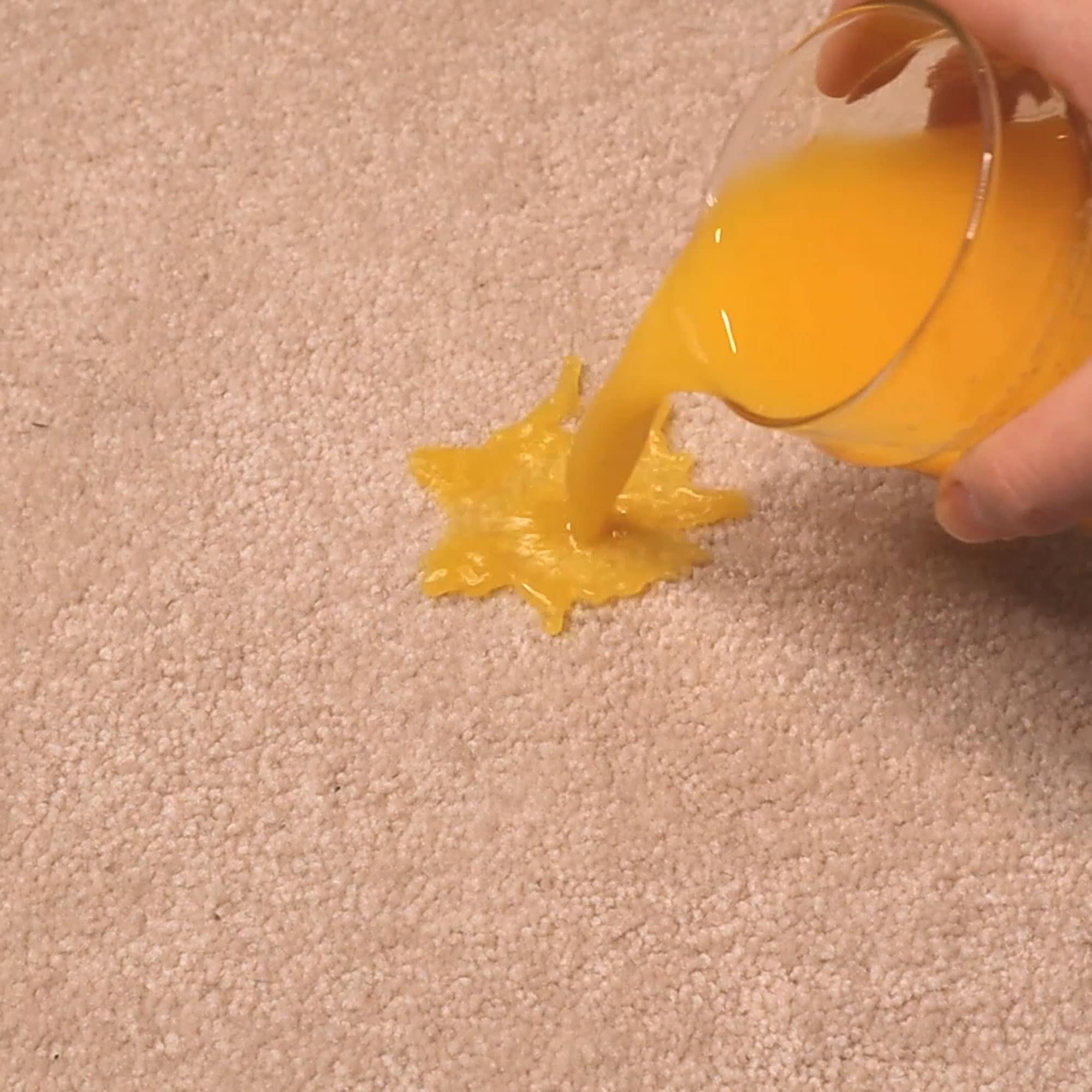 orange juice being spilled on carpet