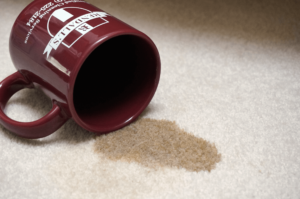 a mug of spilled coffee on carpet